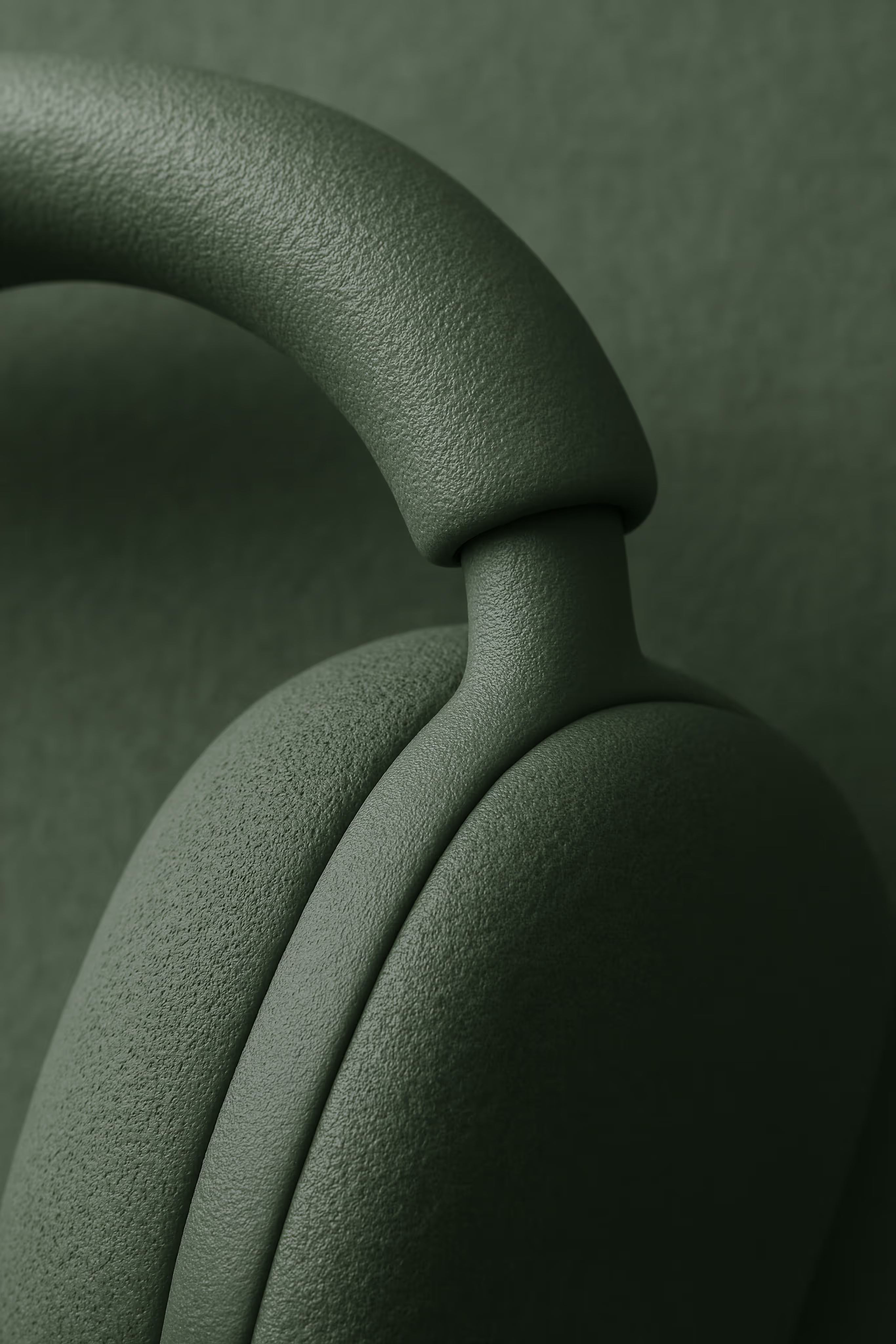 Close-up of textured green headphones focusing on the ear cup and headband connection.