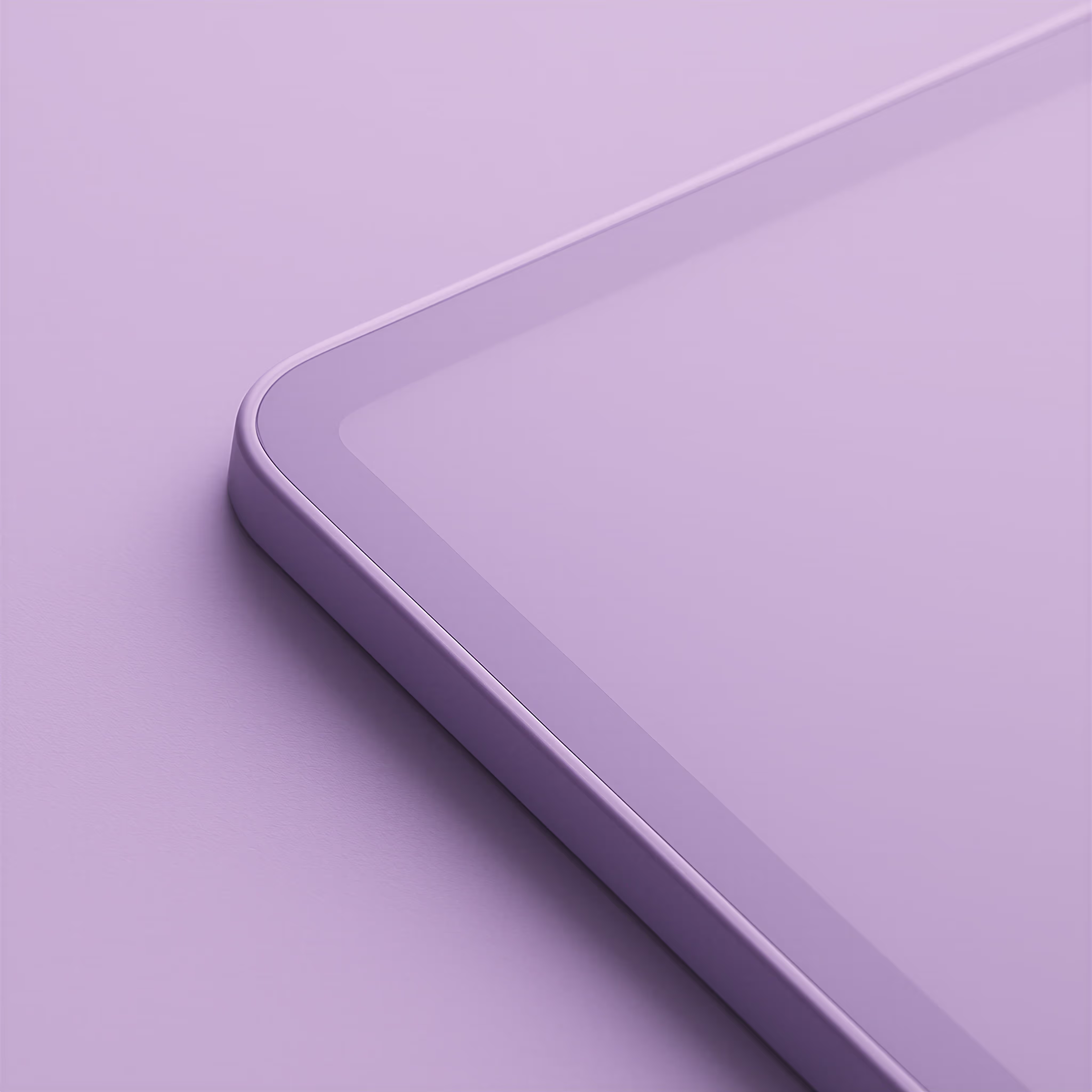 Close-up of a corner of a tablet with a smooth glass screen and rounded edges on a purple surface.